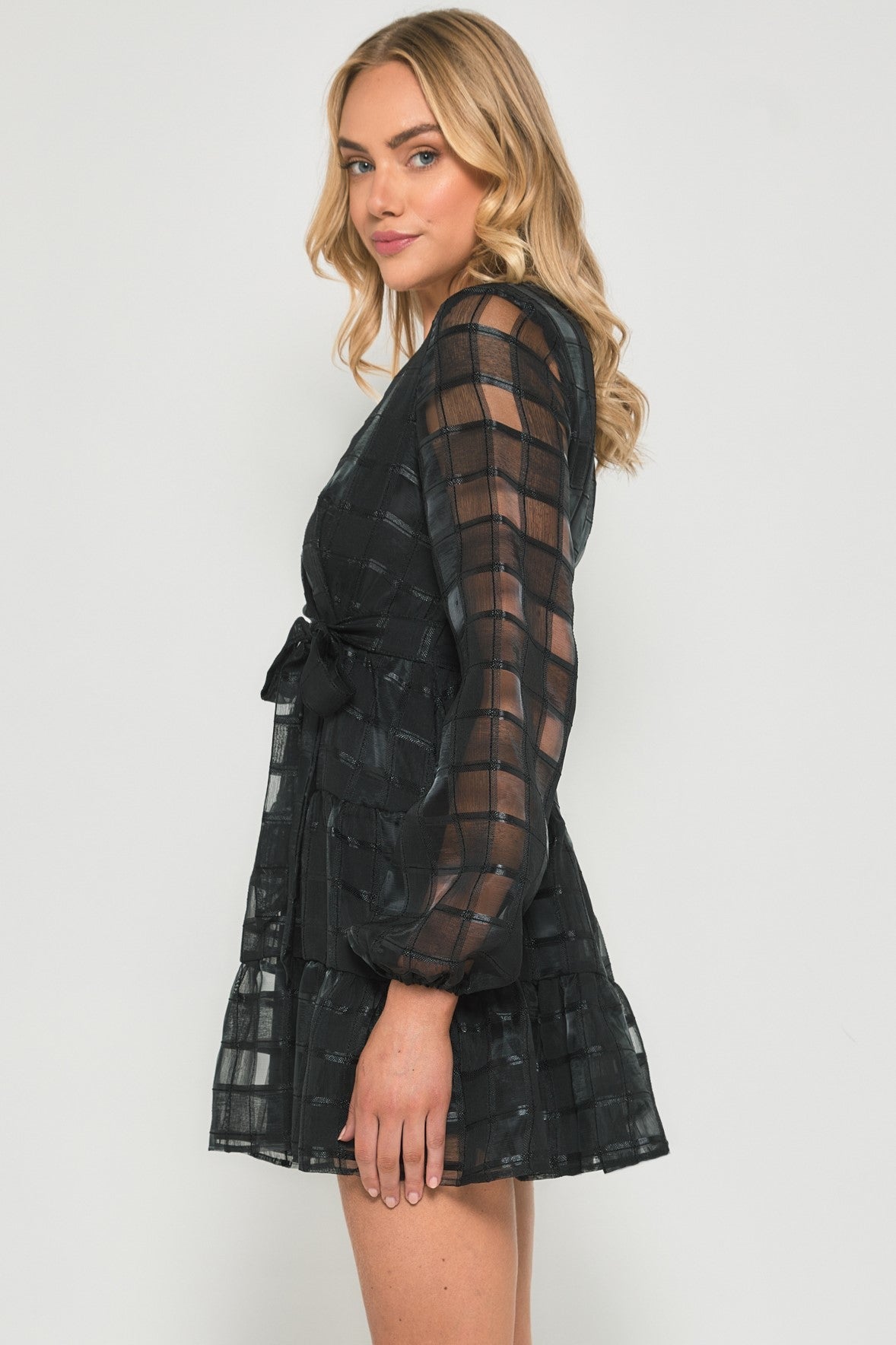 Black sheer long-sleeve mini dress with flared sleeves and tiered hem