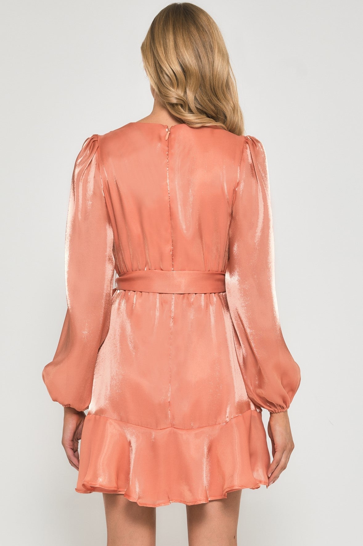 Peach shimmer wrap dress, back view with long balloon sleeves and tie belt at waist