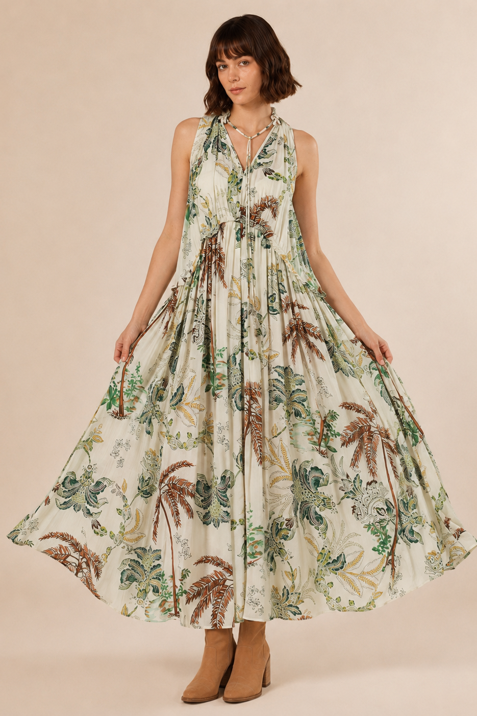 Earth & Fern Maxi Dress front view — lush botanical palm and fern print in earthy greens and cream, sleeveless with tie neck and gathered drawstring waist