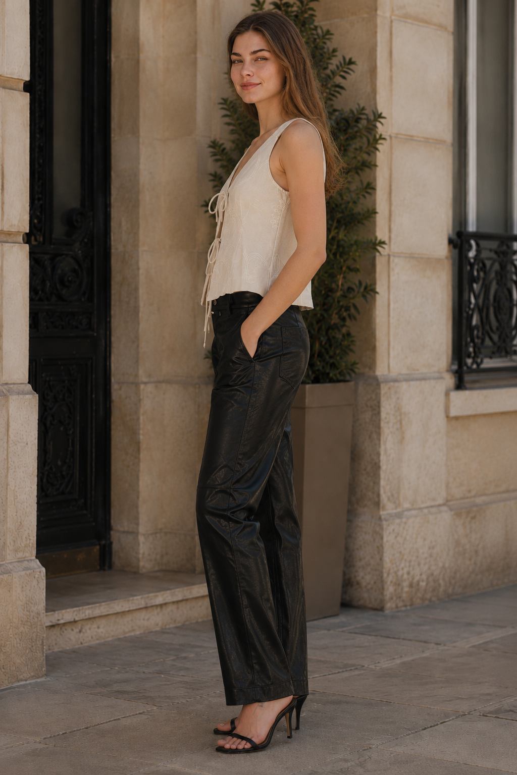 Élodie Tie Front Top side view — relaxed cropped silhouette with tie-front detail, styled with black leather trousers and strappy heels