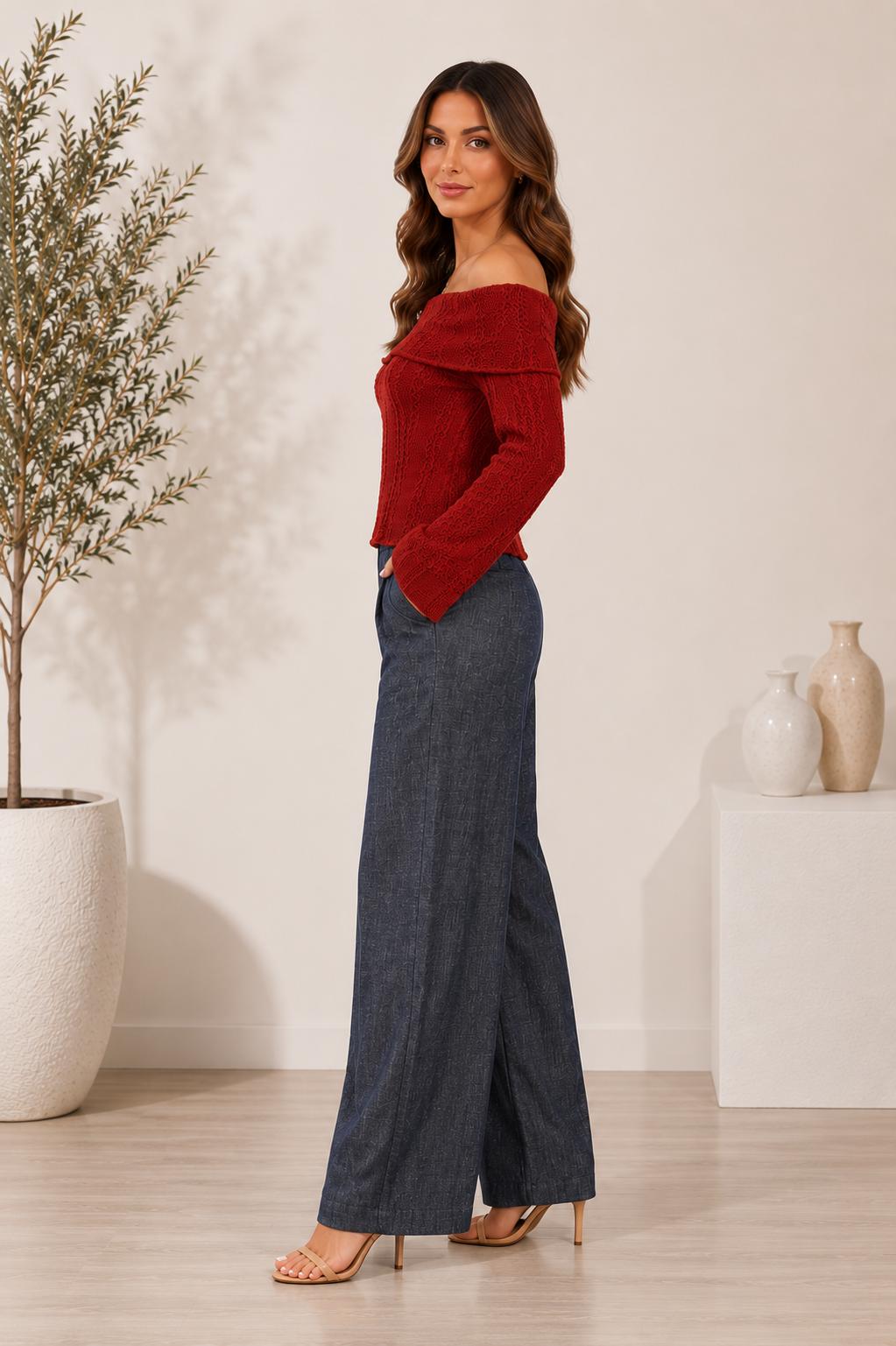 Model wearing grey-blue textured wide-leg pants with front pockets, a wooden button and an elasticated back waistband.