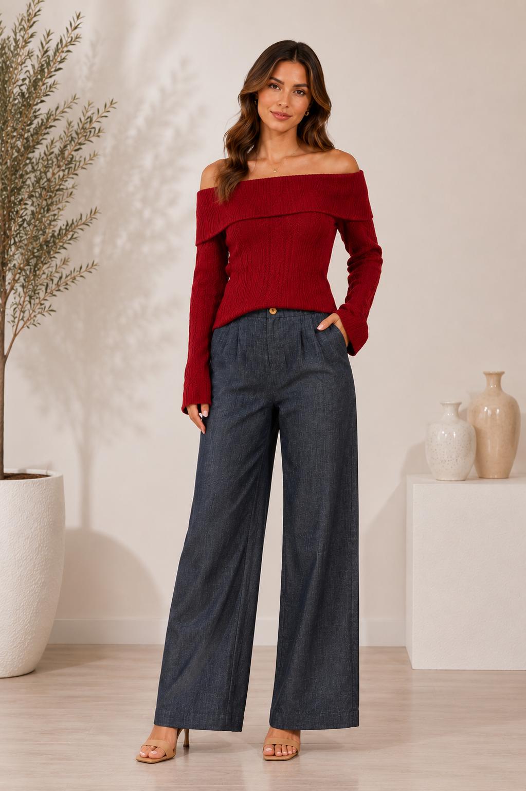 Model wearing grey-blue textured wide-leg pants with front pockets, a wooden button and an elasticated back waistband.