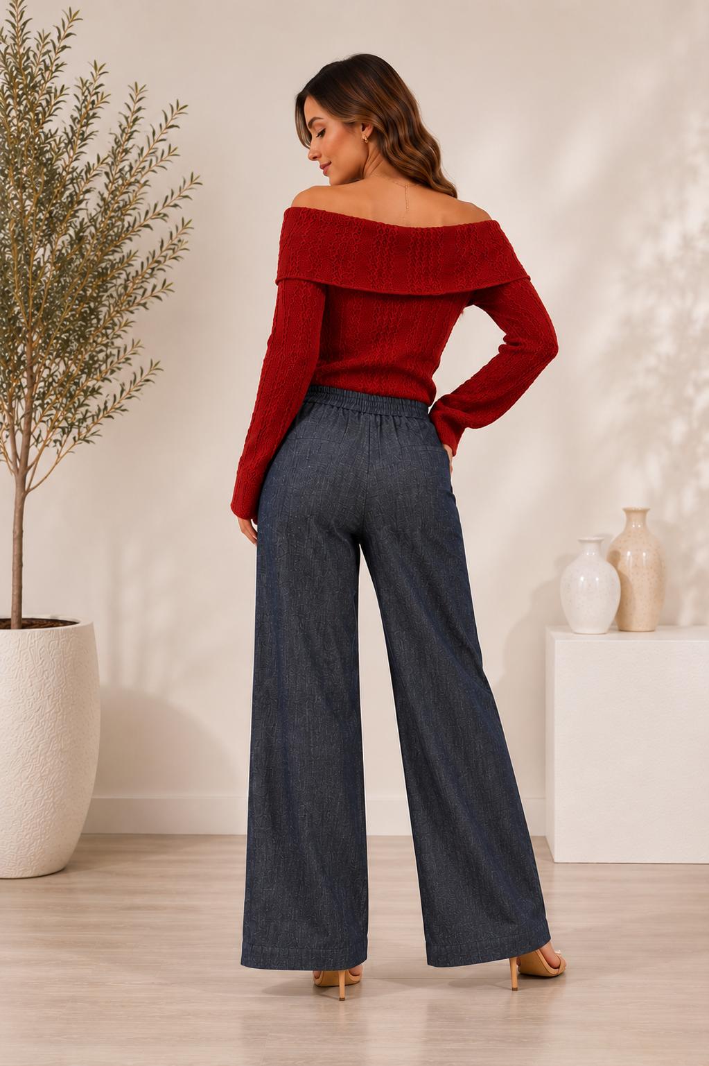 Model wearing grey-blue textured wide-leg pants with front pockets, a wooden button and an elasticated back waistband.