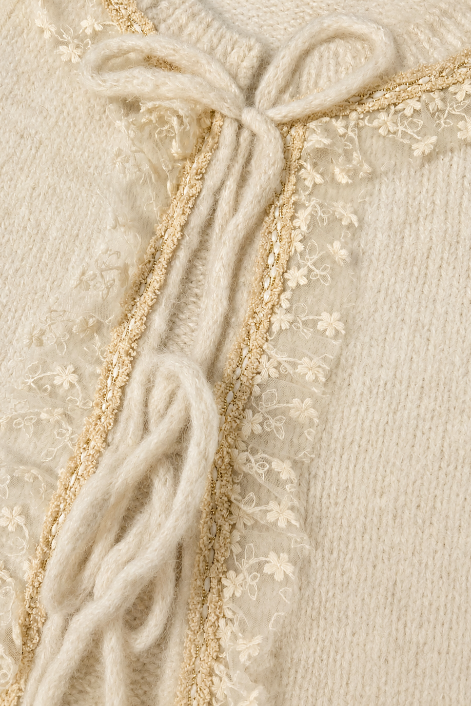 Women's cream knit tie-front cardigan with textured detailing, long sleeves, and a relaxed fit.